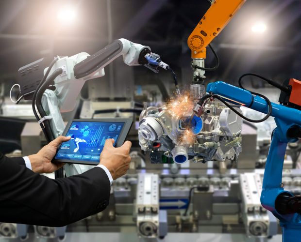 Manager engineer touch screen control automation robot arms the production of factory parts engine manufacturing industry robots and mechanical arm