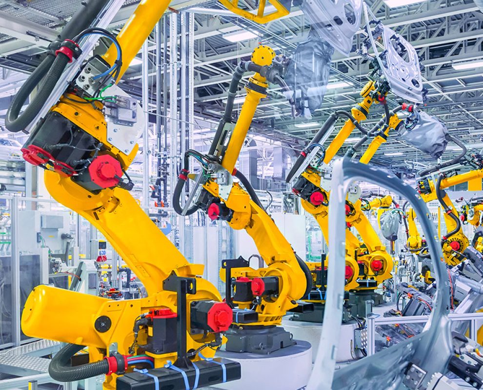 robotic arms in a car plant